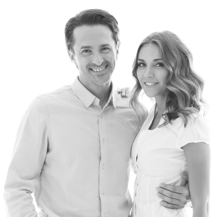 happy-couple-smiling-on-white-background